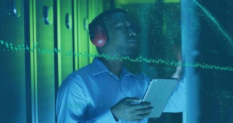 IT Professional Using Tablet for Security in Modern Data Center