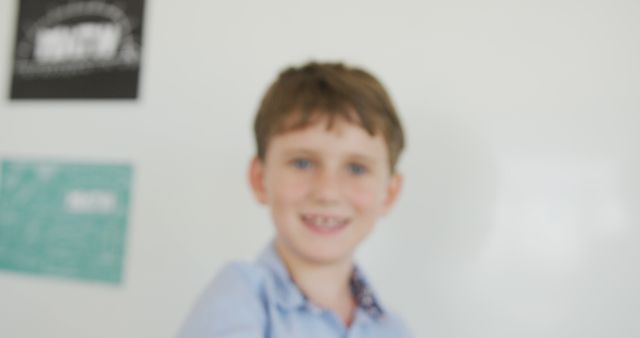 Unclear image of a happy boy with a blurry effect, creating a sense of motion. Suitable for themes of childhood, joy, or depicting focus problems. Can be used for educational websites, articles on photography techniques, or metaphorical representations of unclear vision or memories.