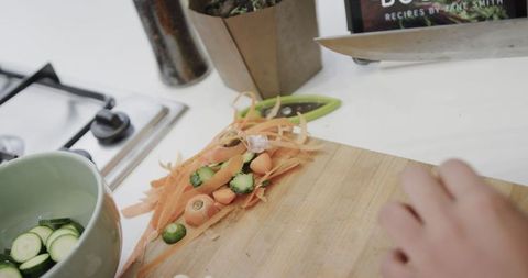 Hands Chopping Fresh Vegetables on Wooden Board in Home Kitchen