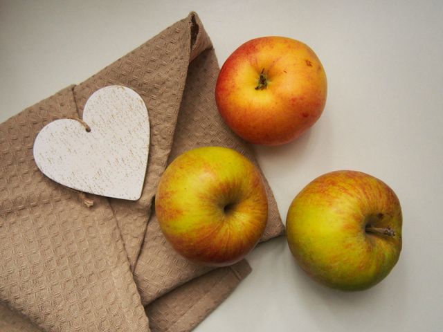 Fresh Apples and Rustic Heart on Beige Textile - Download Free Stock Photos Pikwizard.com
