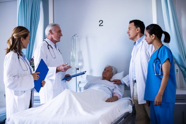 Medical team consulting with an elderly patient and family member in a hospital room. Ideal for illustrating healthcare services, patient care, medical consultations, and teamwork in healthcare settings.