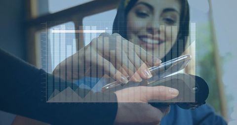 Digital payment transaction with smartphone and chart overlay