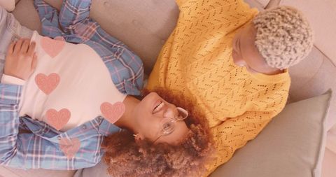 Diverse Couple Relaxing on Sofa Displaying Love and Happiness