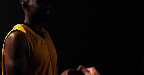 Basketball Players High-Fiving in Dimly Lit Court - Download Free Stock Images Pikwizard.com