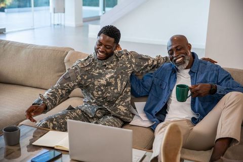 Father and Son Bonding Over Coffee and Technology at Home
