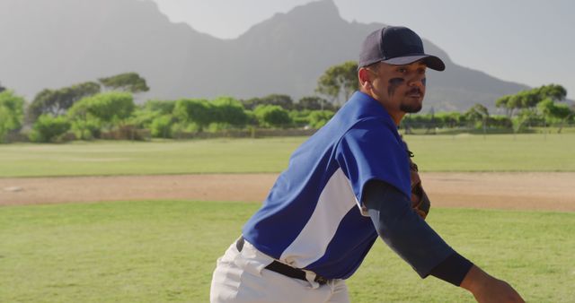 Baseball Player Pitching on Sunny Field with Mountains in Background - Download Free Stock Images Pikwizard.com