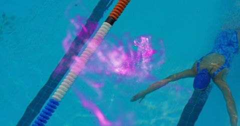 Female Swimmer Training in Pool Creating Vivid Water Effects