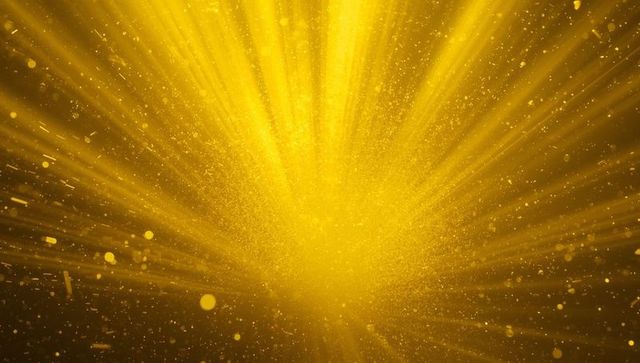 Radiant Golden Light Burst with Sparkling Dust Particles