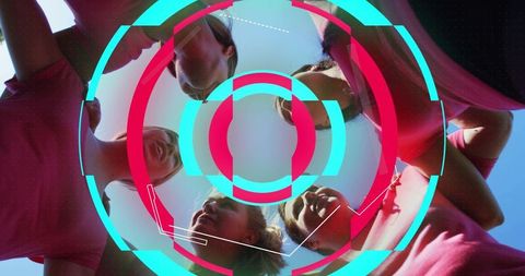 Team huddling in circle on sunny field with neon hud overlay for sports unity and broadcast