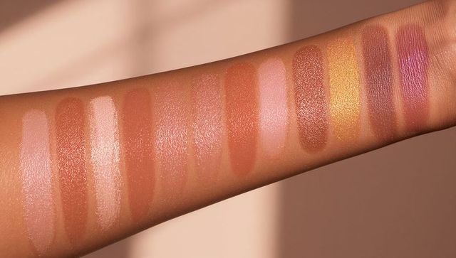 Colorful makeup swatches on forearm in soft light