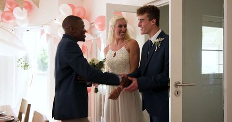 Happy Bride and Groom Welcoming Guests at Home Wedding Ceremony
