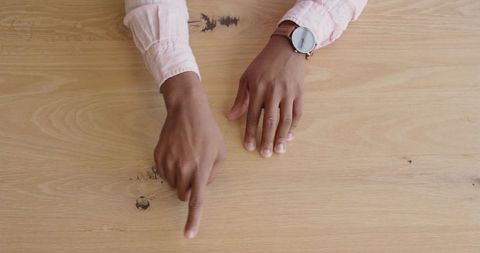 Hands expressing ideas during discussion on wooden table