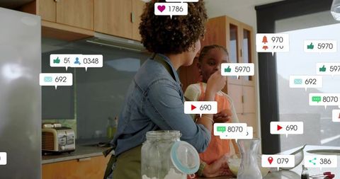 Feeding child at kitchen counter with floating social media notifications, cozy morning
