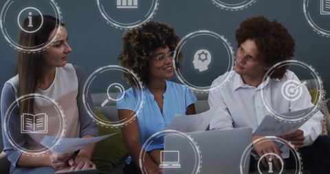 Team collaborating in modern office lounge with digital interfaces