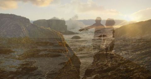 Couple Exploring Scenic Coastal Landscape at Sunset