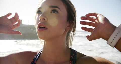 Carefree Young Woman Enjoying Sunlight at Beachside - Download Free Stock Images Pikwizard.com