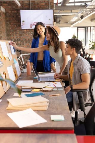 Diverse team collaborating in urban open-plan office