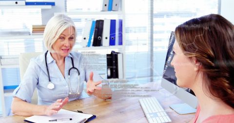 Female doctor consulting patient in tech-enhanced clinic