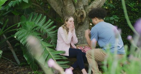 Diverse Couple Enjoying a Garden Picnic with Happiness