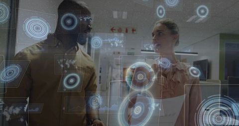 Coworkers reviewing augmented reality holographic business data collaborating in office corridor