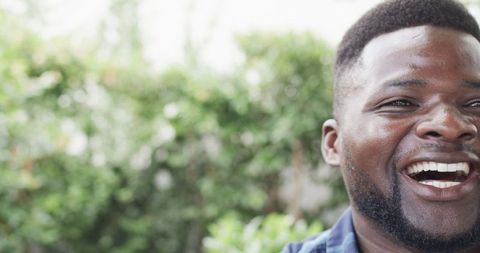 Joyful Man Reflecting in Sunlit Garden