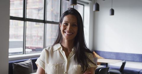 Confident Businesswoman Smiling Brightly in Modern Office Space