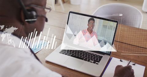 Businessman video conferencing with data overlay graphics