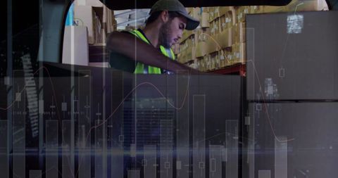 Warehouse worker handling inventory against financial data overlay