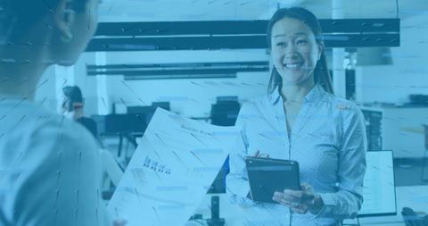 Project leader sharing insights with co-worker in modern office