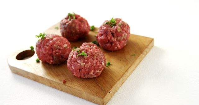 Raw Meatballs on Wooden Board with Fresh Herbs - Download Free Stock Images Pikwizard.com