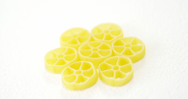 Close-up of Yellow Pasta Wheels on White Background - Download Free Stock Images Pikwizard.com