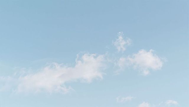 Minimal Pale Blue Sky with Wispy Horizontal Cloud Band for Calm Background and Branding