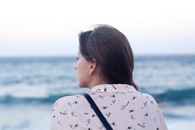 Woman Gazing at Ocean Horizon in Thoughtful Moment - Download Free Stock Images Pikwizard.com