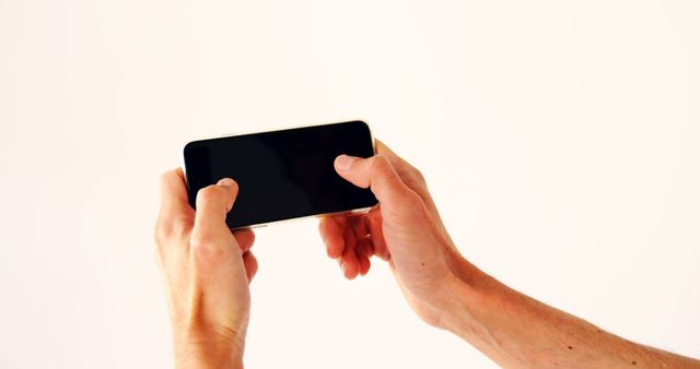 Hands playing mobile game on smartphone with white background - Download Free Stock Images Pikwizard.com