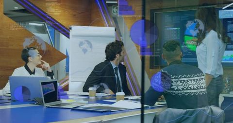 Presenting executive team reviewing live analytics dashboards in collaborative boardroom meeting
