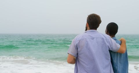 Rear View of Close Couple Embracing on Serene Beach