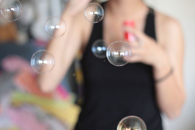 Woman in Black Tank Top Blowing Soap Bubble - Download Free Stock Photos Pikwizard.com