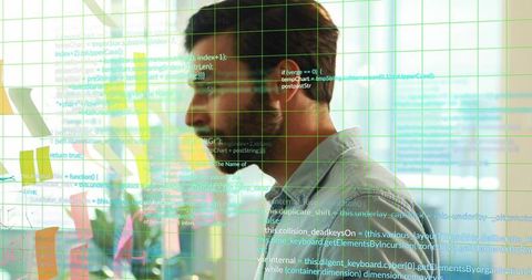 Software Engineer Scanning Code on Glass Wall with Sticky Notes, Greenery, Grid Overlay