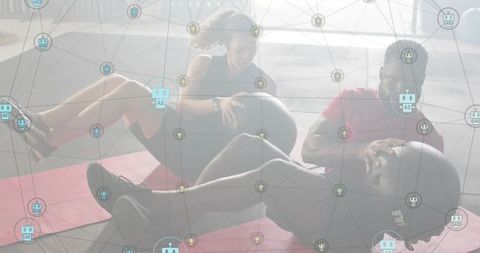 Workout partners doing russian twists with medicine balls on mats with ai network overlay