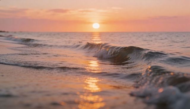 Golden sunset waves reflecting on wet sand, calm pastel seascape at horizon