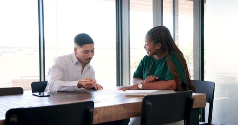 Colleagues Collaborating on Project at Office Conference Table