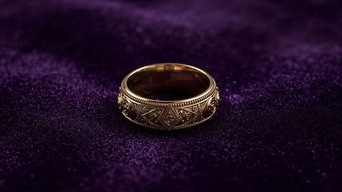 Ornate gold ring on elegant purple velvet background