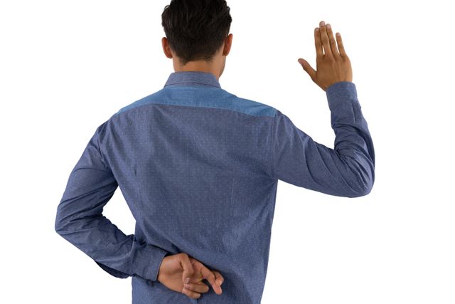 Rear view of businessman waving hand with crossed fingers while standing against white background