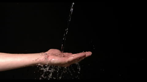 Slow Motion Water Flowing on Open Hand
