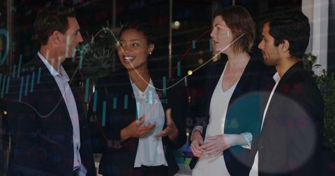 Discussing strategy: diverse team collaborating over market charts in modern office