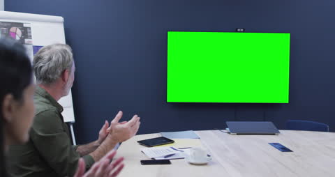 Diverse Team Meeting with TV Green Screen for Presentation