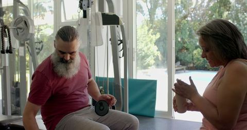 Senior Couple Enjoying Weight Training at Home Gym