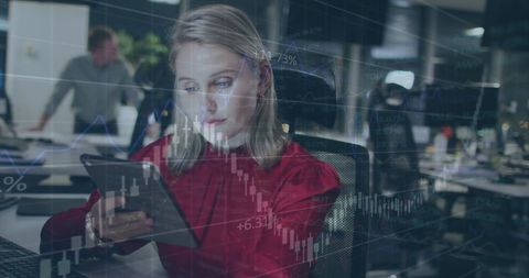 Businesswoman analyzing data on tablet computer