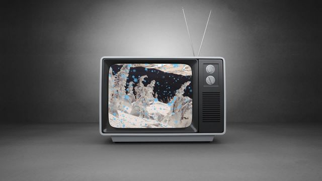 Vintage TV displays snowy winter wonderland with falling snowflakes, creating nostalgic atmosphere. Suitable for holiday promotions, retro-themed projects, winter adverts, and vintage decor inspiration.