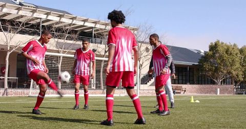 African American Soccer Players Practicing Strategy as Team